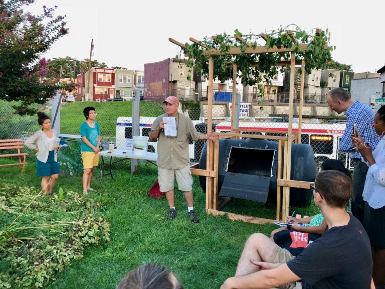 Tony Guido explains features of a composting vessel he helped build for a Philadelphia Food Policy Advisory Council design competition. (Meir Rinde/PlanPhilly)