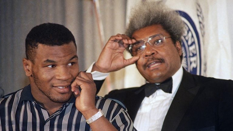 Mike Tyson, left, stands with fight promoter Don King during a news conference on Wednesday, June 25, 1987. (AP Photo/Paul Burnett)