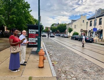 Kelli McIntyre and Andy Trackman check out walking conditions along Germantown Avenue during a FeetFirstPhilly walk audit. (Meir Rinde/PlanPhilly)