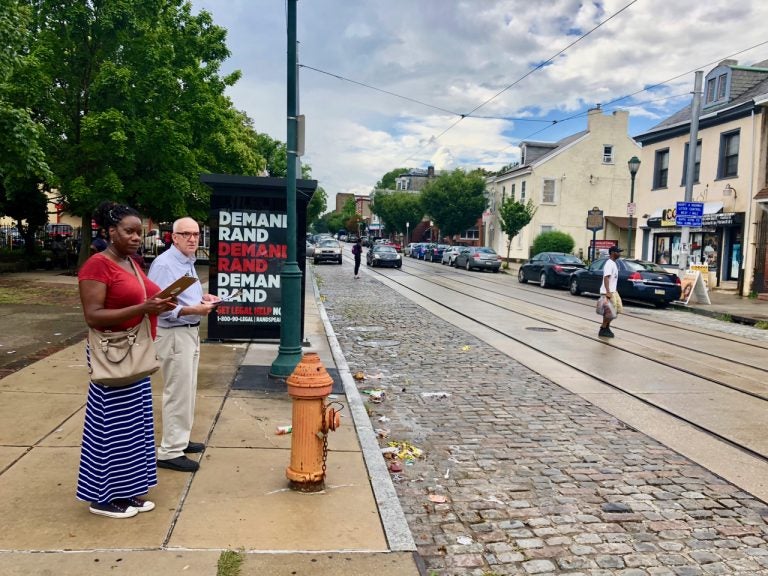 Kelli McIntyre and Andy Trackman check out walking conditions along Germantown Avenue during a FeetFirstPhilly walk audit. (Meir Rinde/PlanPhilly)