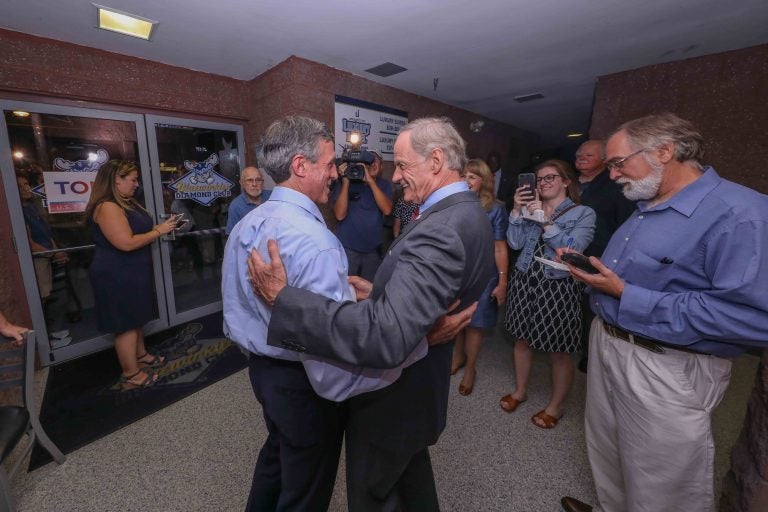 United States Senator Tom Carper (right) greets Governor John Carney during a Primary Election gathering Thursday, Sept. 06, 2018, at Frawley Stadium in Wilmington, Delaware. (Saquan Stimpson/for WHYY)