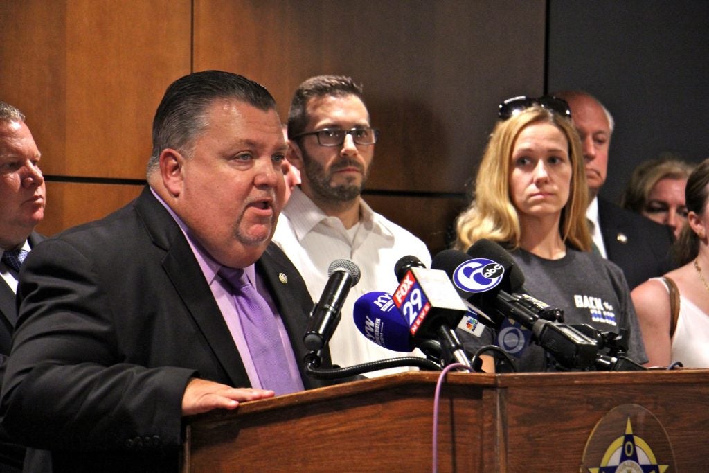 Philadelphia Fraternal Order of Police President John McNesby speaks in support of ex-police officer Ryan Pownall, charged with murder in the shooting of David Jones. Pownall's family members (from right) wife Tina Pownall and brother Edward Pownall, look on.