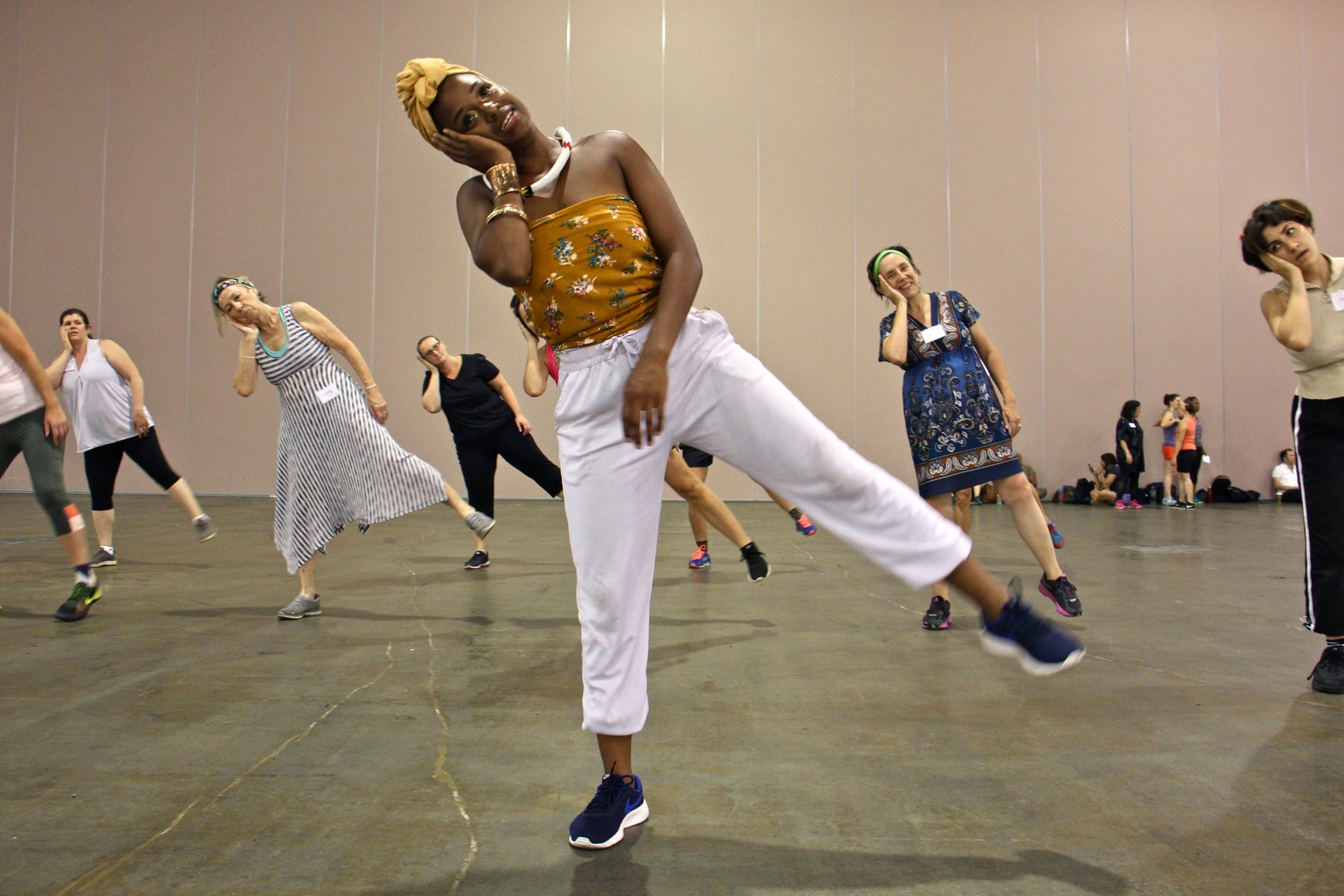 Rehearsal assistant Sanchel Brown leads a group warmup during rehearsal for "Le Super Grand Continental," which will be performed by 175 volunteer dancers at the steps of the Philadelphia Art Museum during the Fringe Festival. 