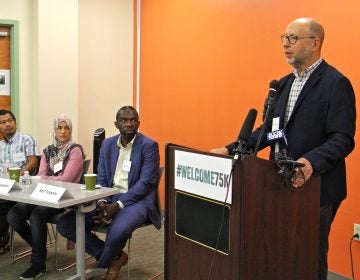 Dr. David S. Glosser speaks in support of the U.S. Resettlement Program. He is joined by former refugees (from left) Gin Sum, who fled religious persecution in Burma, Bdour Hussein, who fled the war in Syria, and Sozi Tulante, who came to Philadelphia as a political refugee in 1983.