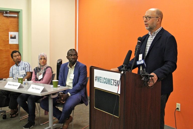 Dr. David S. Glosser speaks in support of the U.S. Resettlement Program. He is joined by former refugees (from left) Gin Sum, who fled religious persecution in Burma, Bdour Hussein, who fled the war in Syria, and Sozi Tulante, who came to Philadelphia as a political refugee in 1983.