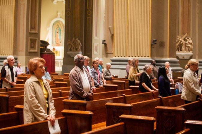 Philadelphia area catholics attended a mass Friday evening at the Basillica of Saints Peter and Paul for a night of prayer and reflection following the recent revelations of wide spread sexual abuse by priests across the state. (Brad Larrison for WHYY)
