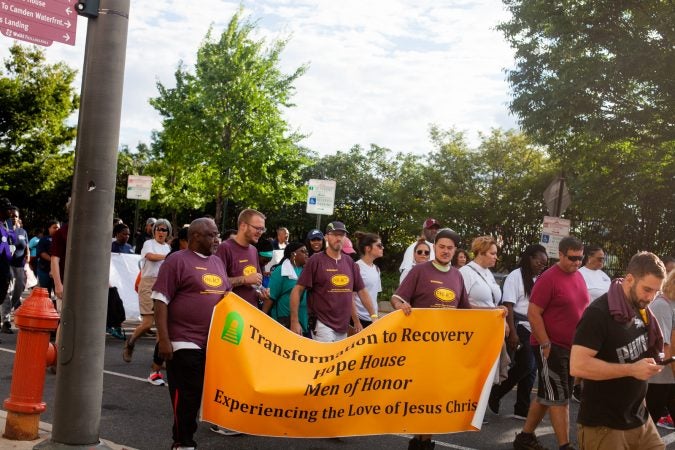 Participants in the 2018 Recovery Walk march through Old City Philadelphia Saturday morning. (Brad Larrison for WHYY)