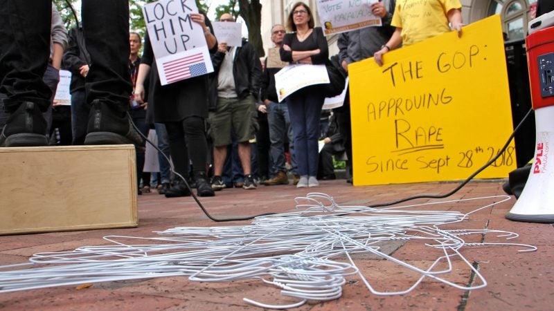 Wire hangers dumped by a protester lie on the ground at the center of a demonstration against Brett Kavanaugh for U.S. Supreme Court. About 200 gathered outside the United States Custom House at 200 Chestnut Street to voice their objections to Kavanaugh's nomination in light of sexual assault allegations. (Emma Lee/WHYY)