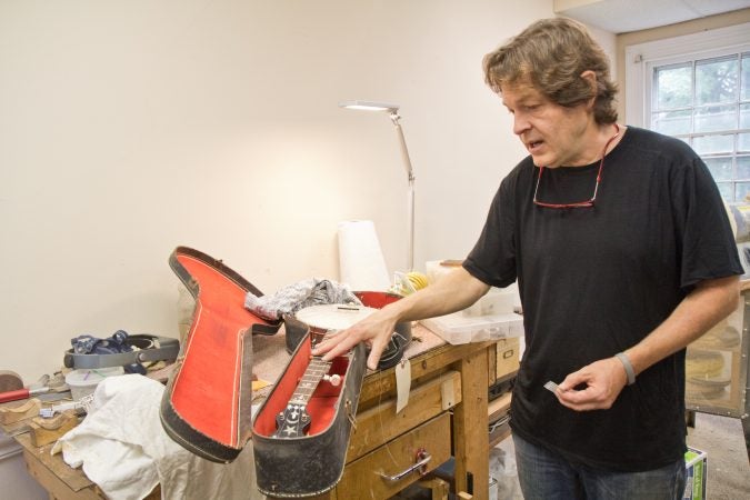 Tim Huenke, restorative luthier and owner of Superior Guitar Works, recently restored a 100-year-old Princess Banjo. (Kimberly Paynter/WHYY)