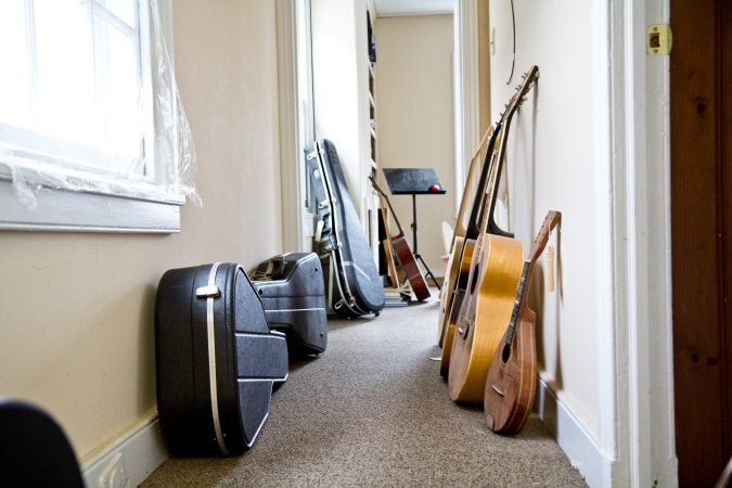 Guitars and a mandolin await the attention of restorative luthier Tim Huenke at Superior Guitar Works in Flourtown. (Kimberly Paynter/WHYY)