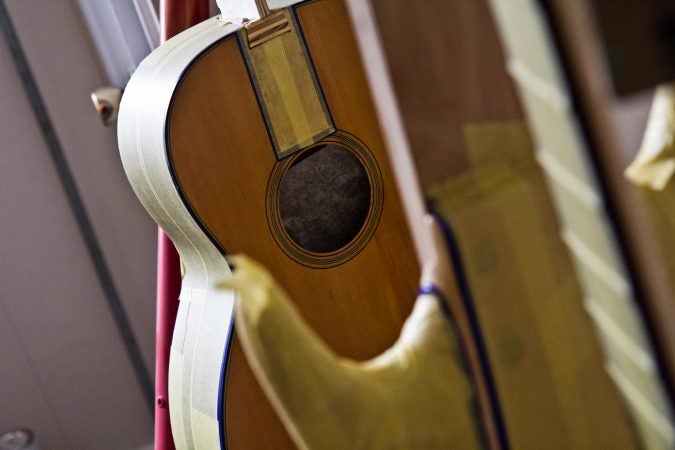Guitars await the attention of restorative luthier Tim Huenke at Superior Guitar Works in Flourtown. (Kimberly Paynter/WHYY)
