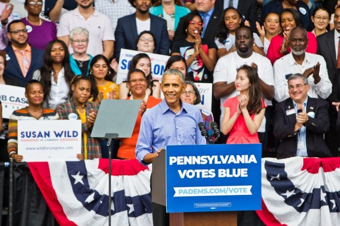 Former President Barack Obama has the crowd on its feet during a rally Friday in North Philadelphia. (Kimberly Paynter/WHYY)