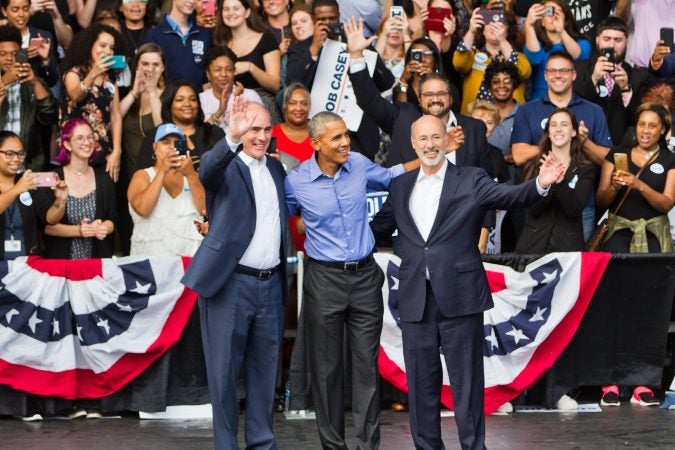 Former President Barack Obama campaigns with  U.S. Sen. Bob Casey (left) and Gov. Tom Wolf at the Dell Music Center in North Philadelphia. (Kimberly Paynter/WHYY)