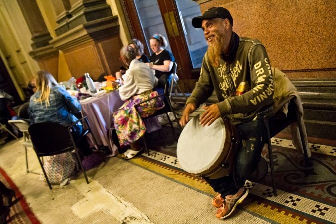 Arnold “Red Bonz” drums for the knitters at the annual Knit In at Philadelphia City Hall. (Kimberly Paynter/WHYY)