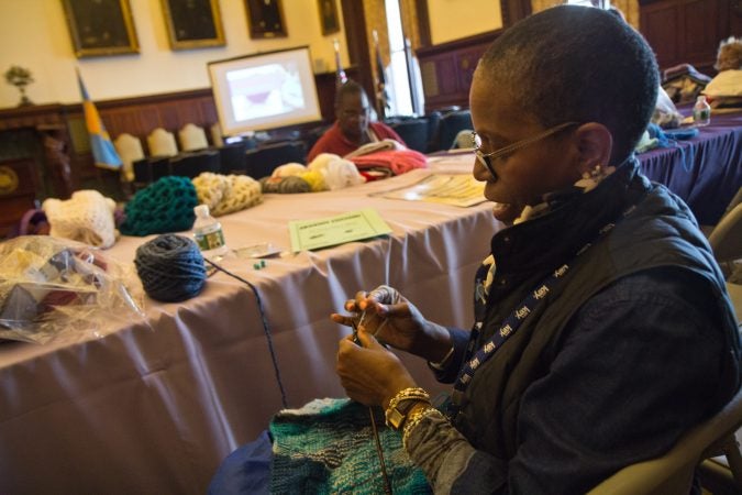 Sakinah Scott is a volunteer with the Knit In and loves to see people coming together for a greater good. Joyce Roby-Washington says her knitting is therapeutic and helps with her dexterity. (Kimberly Paynter/WHYY)