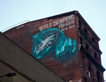 A mural commemorating the Eagles’ Super Bowl win is being installed on Sansom Street between 13th and Broad streets in Center City Philadelphia. (Kimberly Paynter/WHYY)