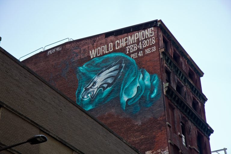 A mural commemorating the Eagles’ Super Bowl win is being installed on Sansom Street between 13th and Broad streets in Center City Philadelphia. (Kimberly Paynter/WHYY)