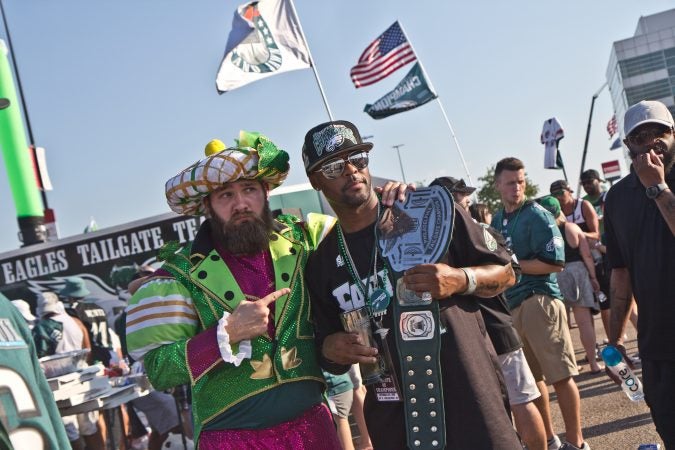 Brennen Dickerson take a photo with Michael Suggs, who traveled from San Antonio to attend the game. (Kimberly Paynter/WHYY)