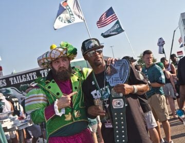 Brennen Dickerson take a photo with Michael Suggs, who traveled from San Antonio to attend the game. (Kimberly Paynter/WHYY)