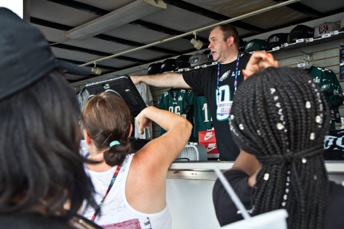 Eagles fans purchase gear at the celebratory event at Penn’s Landing of day of the Eagles’ season opener. (Kimberly Paynter/WHYY)