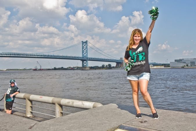 Megan Kelly raises her Eagles pompoms for the team’s season opener tonight. (Kimberly Paynter/WHYY)