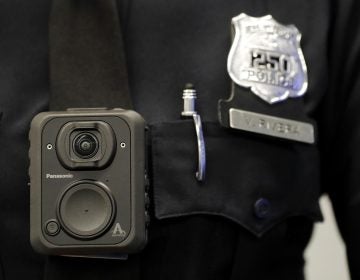FILE -  In this April 26, 2017 file photograph, a Newark, N.J. police officer displays how a body cam is worn during a news conference in Newark. (AP Photo/Julio Cortez, File)