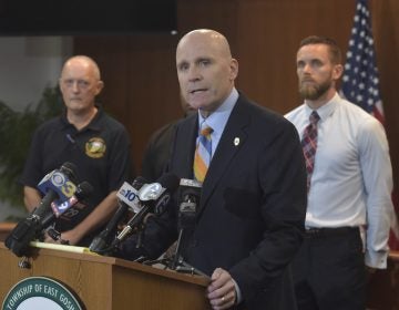 Chester County District Attorney Tom Hogan speaks about the shooting at Bellingham Retirement Community on East Boot Road in East Goshen Township, Pa., Wednesday, Sept. 19, 2018. Authorities are searching for a man who they say shot at his ex-wife and then killed his parents at the retirement center. Hogan says authorities are looking for 59-year-old Bruce Rogal of Glenmoore. (Pete Bannen/Daily Local News via AP)