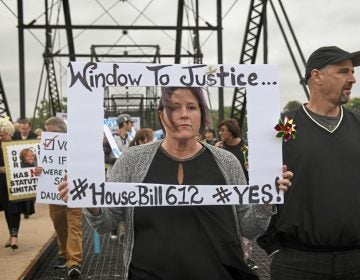 Kelly Williams carries a sign voicing support for legislation that would change the statute of limitations for child sex crimes, during a march in Harrisburg, Pa., Monday, Sept. 24, 2018. At right is her husband Brent. A proposal to give victims of child sexual abuse a two-year window to sue over allegations that would otherwise be too old to pursue was overwhelmingly approved by the state House on Monday, as supporters cheered from the gallery. (Steve Mellon/Pittsburgh Post-Gazette via AP)