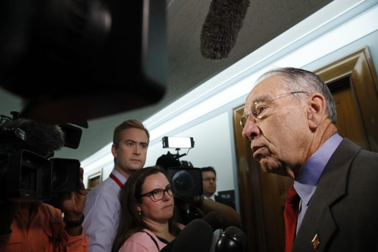 Sen. Chuck Grassley, R-Iowa, right, chair of the Senate Judiciary Committee, answers questions from reporters about allegations of sexual misconduct against Supreme Court nominee Brett Kavanaugh, Wednesday, Sept. 26, 2018, as he arrives for a Senate Finance Committee hearing on Capitol Hill in Washington. (AP Photo/Jacquelyn Martin)