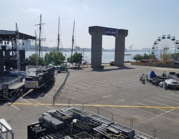 Workers set up up for the NFL Kickoff Experience at Penn's Landing, leading into the Eagles' home opener Thursday. (Sara Hoover for WHYY)