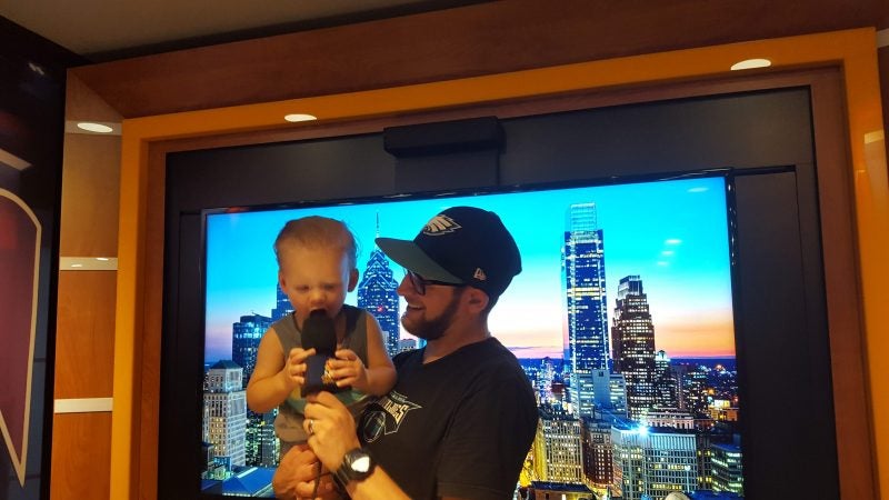 Marco Lerro and his son, Bruno, check out the  “Sunday Night Football on NBC” tour bus. (Sara Hoover for WHYY)