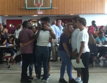 Students embrace a day after learning their charter school is closing. (Zoe Read/WHYY)