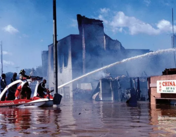 Firefighters battle a fire in flood ravaged Bound Brook, New Jersey during Tropical Storm Floyd in Sept. 1999. 