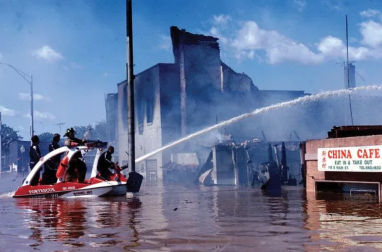 Firefighters battle a fire in flood ravaged Bound Brook, New Jersey during Tropical Storm Floyd in Sept. 1999. 