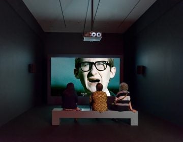 The leader of a fictional movement to repopulate Poland with Jews delivers a speech in an installation view of 