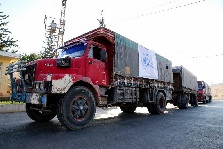 A World Food Programme convoy carries humanitarian aid to Aleppo, Syria. Getting food into conflict zones is a major hurdle — and a topic of discussion at the WFP's Innovation Accelerator. (Cem Genco/Anadolu Agency/Getty Images)