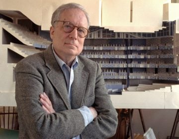 FILE - In this April 1991 file photo, architect Robert Venturi poses in his office in the Manayunk section of Philadelphia, with a model of a new hall for the Philadelphia Orchestra in background. Venturi, who turned austere modern design on its ear, ushering in postmodern complexity with the dictum 