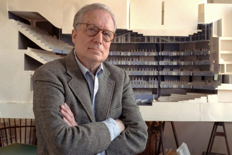 FILE - In this April 1991 file photo, architect Robert Venturi poses in his office in the Manayunk section of Philadelphia, with a model of a new hall for the Philadelphia Orchestra in background. Venturi, who turned austere modern design on its ear, ushering in postmodern complexity with the dictum 