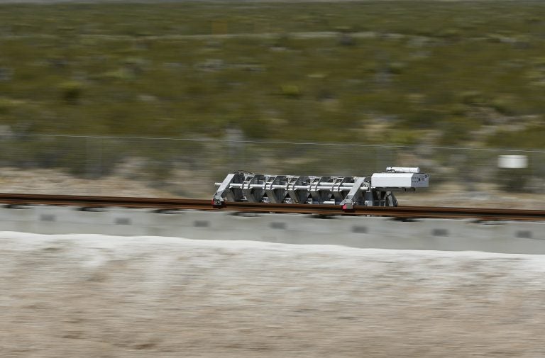 A sled speeds down a track during a test of a Hyperloop One propulsion system, Wednesday, May 11, 2016, in North Las Vegas, Nev. The startup company opened its test site outside of Las Vegas for the first public demonstration of technology for a super-speed, tube based transportation system. (AP Photo/John Locher)