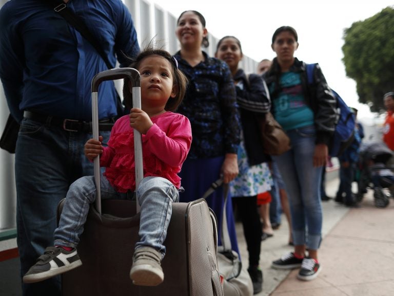 Asylum seekers line up at the San Ysidro port of entry in Tijuana, Mexico. The ACLU announced today a preliminary agreement with the Trump administration to allow some parents already in the U.S. but separated from their children at the border to apply for asylum.
(Gregory Bull/AP)