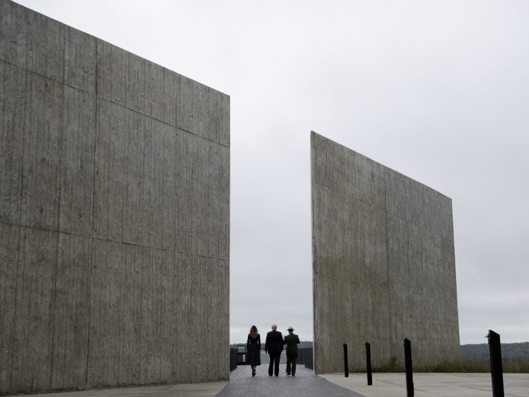 President Trump walks with Melania Trump and National Parks and National Parks superintendent Stephen Clark through the Flight 93 National Memorial in Shanksville, Pa., on Tuesday.