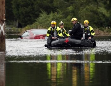 Members of a swift water rescue team check a flooded street caused by the tropical storm Florence in New Bern, N.C., on Saturday. Rescuers have pulled more than 200 people from their homes to safer ground as of Saturday morning in New Bern. (Chris Seward/AP)