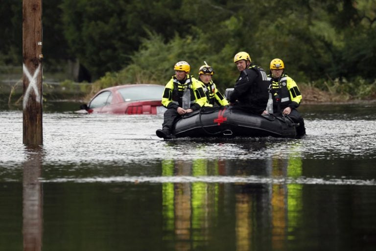 Members of a swift water rescue team check a flooded street caused by the tropical storm Florence in New Bern, N.C., on Saturday. Rescuers have pulled more than 200 people from their homes to safer ground as of Saturday morning in New Bern. (Chris Seward/AP)