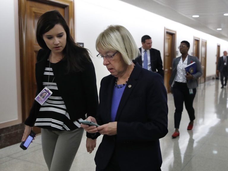 Sen. Patty Murray, D-Wash., works on her cellphone on Capitol Hill. In a recent letter, Sen. Ron Wyden said some senators and Senate staff members were warned that their personal email accounts were targeted by foreign government hackers. (Jacquelyn Martin/AP)