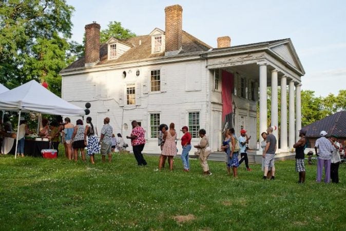 Guests line up for BBQ at a June 29 community celebration held at Hatfield House.