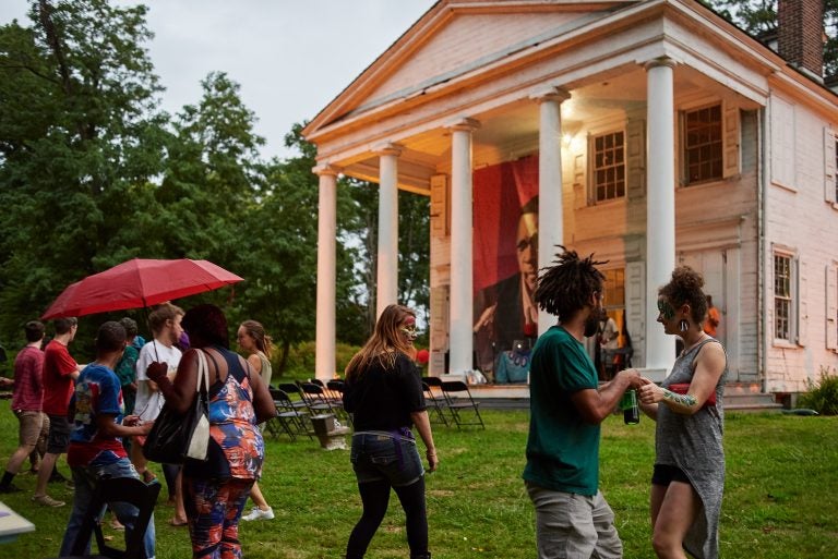 Strawberry Mansion residents mingle on the lawn of the Hatfield House at an art and storytelling event hosted by Amber Art and Design in July. (Albert Yee for Fairmount Park Conservancy)