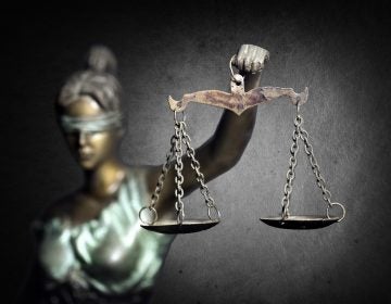 Lady Justice or Justilia or Themis against dark background