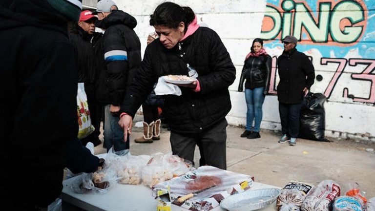 A local church distributes food and clothes to residents in need in the Kensington section in Philadelphia. (Spencer Platt/Getty Images)