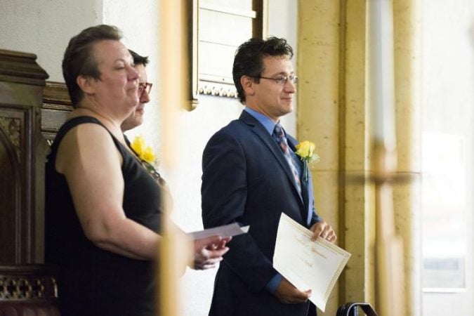 (From left) Architect Kathy Dowdell, Ryan Spak of the University City District, and David Hincher of Cedar Park Neighbors are honored at Hickman Temple. (Rachel Wisniewski for WHYY)