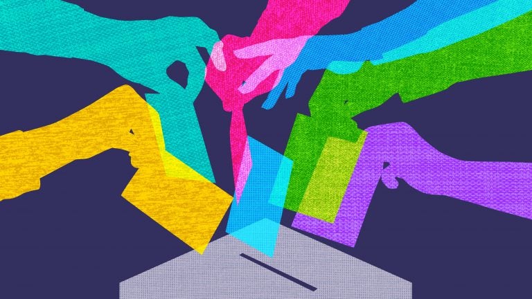 Colourful overlapping silhouettes of hands voting in fabric texture. (smartboy10/Getty Images)